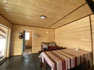 a room with a bed in a wooden room at Шпінь 3 in Vorokhta