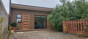 a wooden shed with a fence in front of it at Cabaña Roquin Patagonia in Chile Chico