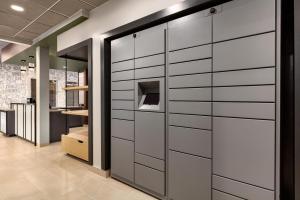 a wall of sliding doors in a room at LivSmart Studios By Hilton Kokomo in Kokomo