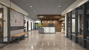 a hallway of a library with a bench and shelves at LivSmart Studios By Hilton Kokomo in Kokomo