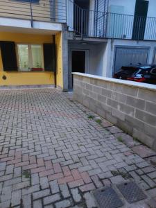 a brick sidewalk in front of a building at Girasole in Alessandria