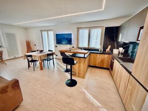 a kitchen with a table and chairs in a room at Nos Sweet Home in Dimaro