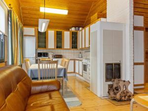 a living room with a couch and a fireplace at Holiday Home Sallassi by Interhome in Salla