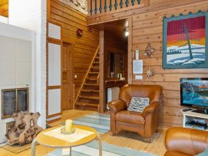 a living room with a chair and a television at Holiday Home Sallassi by Interhome in Salla