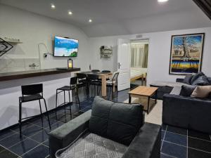 a living room with a couch and a table at Niš Residence in Niš