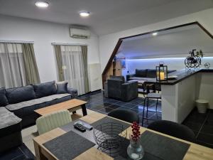 a living room with a couch and a table at Niš Residence in Niš