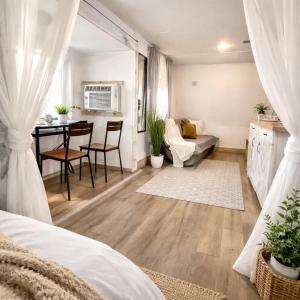 a living room with a bed and a dining room at Social Distanсing Approved Nature Getaway! in Naples