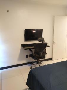 a chair in a room with a desk with a computer at Eco paradise 134 in Cumbuco