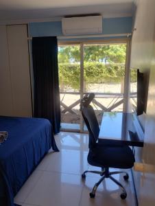 a bedroom with a desk and a chair and a window at Eco paradise 134 in Cumbuco +7 photos