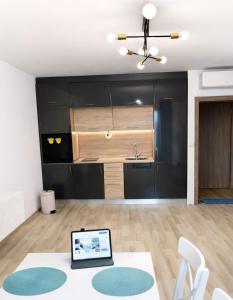 a living room with a table and a kitchen at Apartment Sea Sunrise, complex Carpe Diem, FREE PARKING in Balchik
