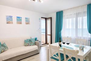 a living room with a couch and a table at Apartment Sea Sunrise, complex Carpe Diem, FREE PARKING in Balchik