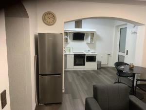 a kitchen with a stainless steel refrigerator and a table at KM APPARTS 5 Wesel in Wesel