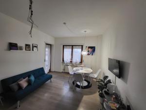 a living room with a blue couch and a table at Civico 16 in Perugia