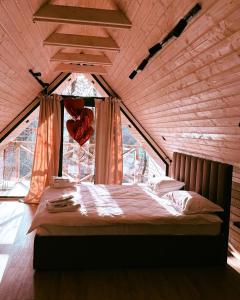 a bed in a room with a large window at SVOI Chalet in Vyshka +88 photos