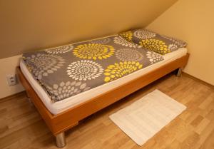 a small bed in a corner of a room at Vanilka in Liptovský Trnovec