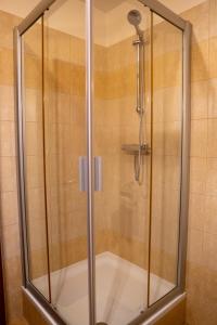 a shower with a glass door in a bathroom at Vanilka in Liptovský Trnovec +10 photos
