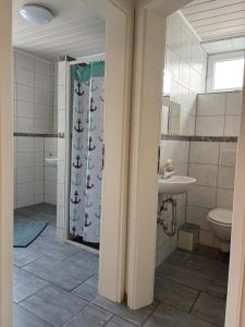 a bathroom with a shower and a toilet and a sink at Monteurwohnungen Am Deich - Ideal für Langzeitaufenthalte in ruhiger Lage in Bremerhaven +58 photos