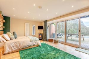 a bedroom with a bed and a large window at 1 Bed in Far Forest oc-d30808 in Rock