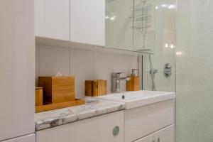 a white kitchen with a sink and a mirror at 1 Bed in Far Forest oc-d30808 in Rock