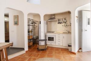 a kitchen with white cabinets and a tile floor at A27 - Caracol Corner Studio in Lagos in Lagos