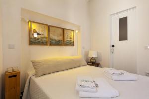 a bedroom with a bed with two towels on it at A27 - Caracol Corner Studio in Lagos in Lagos