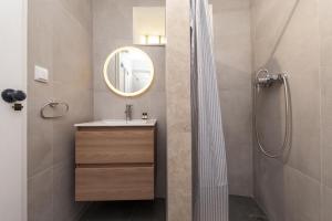 a bathroom with a sink and a mirror at A27 - Caracol Corner Studio in Lagos in Lagos +9 photos