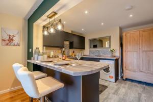 a kitchen with a large island with a counter top at 1 Bed in Far Forest oc-d30808 in Rock +13 photos