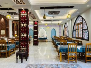 a restaurant with tables and chairs in a room at Amon Hotel in Luxor