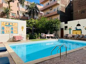 a swimming pool in front of a building at Amon Hotel in Luxor