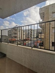 a balcony with a view of a city at Jubeiha Home in Amman