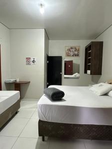 a hotel room with two beds and a bathroom at Hotel Carrão in São Paulo +58 photos