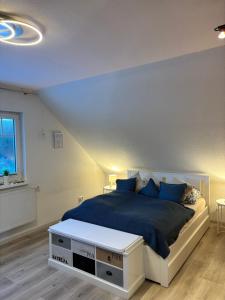a bedroom with a large bed with a blue blanket at 4 Zimmer Ostseetraum in Gneversdorf