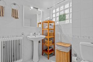 a white bathroom with a sink and a toilet at Fabulous central apartment close to the sea! in Chalkida +77 photos