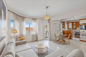 a living room with a couch and a table at Fabulous central apartment close to the sea! in Chalkida