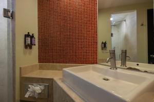 a bathroom with a sink and a mirror and a tub at Fiesta Inn Nogales in Nogales