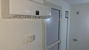 a kitchen with a white stove top oven next to a door at MH Zanzibar in Jambiani