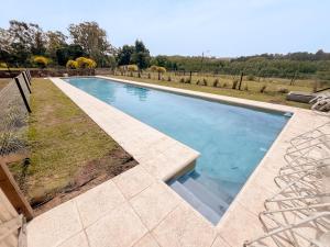 a swimming pool in the middle of a yard at Hotel BIOCERRO in Tandil