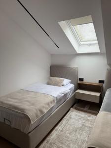 a bedroom with a bed and a skylight at Residence 33 in Sarajevo
