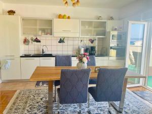 a kitchen and dining room with a table and chairs at Apartment Mandarina in Dugi Rat