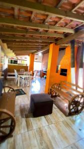 a living room with a table and a table and chairs at Pousada da Heloisa in Imbituba