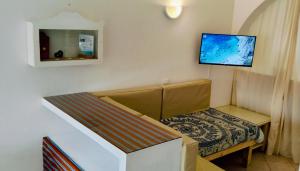 a small room with a bed and a tv on the wall at Canova Apartment in Santa Maria