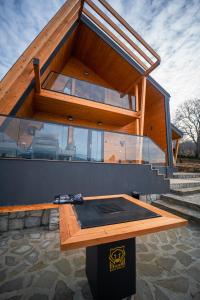 a house with a glass roof on top of it at Royal Hill Bran-A-Frame and Bungalows whit Hot Tub and Sauna in Sohodol