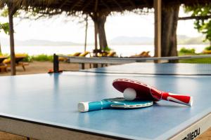 a ping pong paddle and ball on top of a table at Capitán Suizo Beachfront Boutique Hotel in Tamarindo