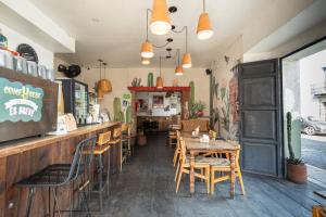 a restaurant with a table and chairs and a bar at Selina Oaxaca in Oaxaca City