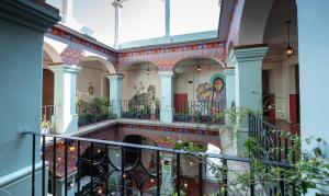 a building with mosaics on the walls and a staircase at Selina Oaxaca in Oaxaca City