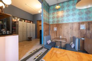 a locker room with blue chairs and a table and lockers at Selina Oaxaca in Oaxaca City +26 photos