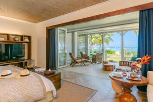 a bedroom with a bed and a view of the ocean at The St. Regis Le Morne Resort, Mauritius in Le Morne