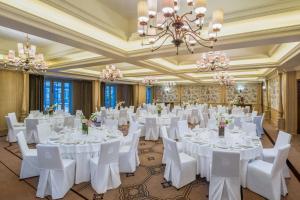 a banquet hall with white tables and chairs and a chandelier at The St. Regis Le Morne Resort, Mauritius in Le Morne +276 photos