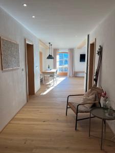 a living room with a couch and a table at Maiergschwendter-Hof inkl. Chiemgaukarte in Ruhpolding