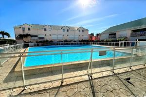 a swimming pool in front of a building at Ti Turtle in Saint-François